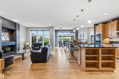 Open-concept living space featuring wood-finish flooring - 5709 Mcluhan Bay, Edmonton, AB 