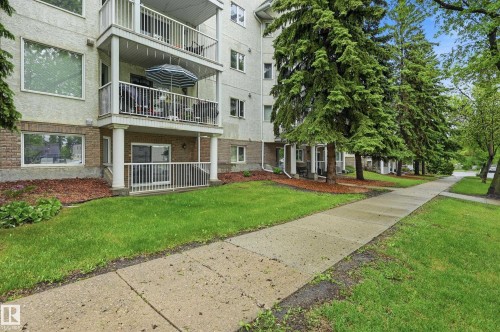 Multi-story building featuring balconies with white railings and support columns - 33 9914 80 Avenue, Edmonton, AB - Outdoor
