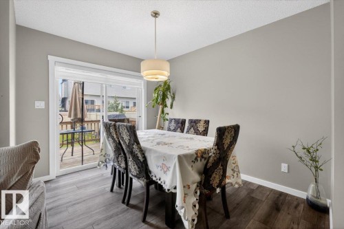 Dining area featuring wood-finish flooring and light gray wall color - 223 40A Avenue, Edmonton, AB - Indoor Photo Showing Dining Room