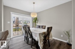 Dining area featuring wood-finish flooring and light gray wall color - 