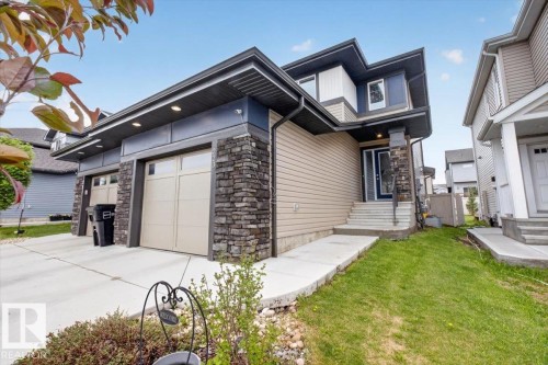 Contemporary facade featuring stacked stone accents and neutral-toned siding - 223 40A Avenue, Edmonton, AB - Outdoor