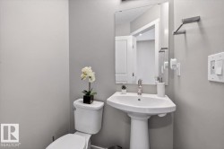 Pedestal sink with chrome faucet, mirror, and wall-mounted towel bar - 