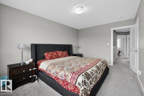 Carpeted bedroom featuring light gray walls, a white ceiling, and a white flush-mount ceiling light fixture - 223 40A Avenue, Edmonton, AB - Indoor Photo Showing Bedroom