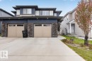 Contemporary two-story exterior featuring a stacked stone facade and dark siding accents - 223 40A Avenue, Edmonton, AB  - Outdoor With Facade 