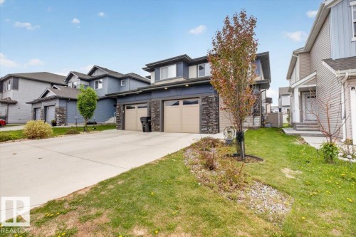 Contemporary facade featuring dark blue siding and stone accents - 223 40A Avenue, Edmonton, AB - Outdoor With Facade