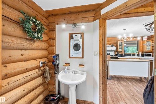 Wood-finish flooring throughout - #17 A 15031 Twp Road 462, Rural Wetaskiwin County, AB - Indoor Photo Showing Laundry Room