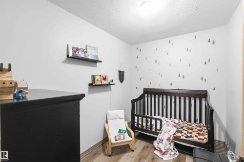 White walls with decorative wall decals, wood-finish flooring, recessed lighting, and floating wall shelves - #17 A 15031 Twp Road 462, Rural Wetaskiwin County, AB - Indoor