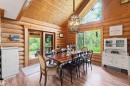 Dining area featuring log walls, wood-finish flooring, a built-in wood ceiling, transom windows, and double French doors providing exterior access - #17 A 15031 Twp Road 462, Rural Wetaskiwin County, AB  - Indoor 