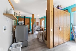 Laundry area featuring a floating wood shelf and a washer hookup - 