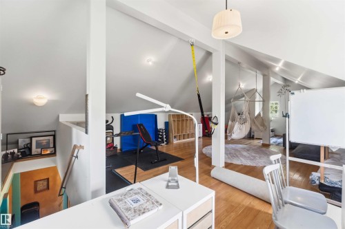 Loft space featuring vaulted ceilings, wood-finish flooring, recessed lighting, and an open layout - #17 A 15031 Twp Road 462, Rural Wetaskiwin County, AB - Indoor