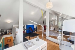 Loft space featuring vaulted ceilings, wood-finish flooring, recessed lighting, and an open layout - 