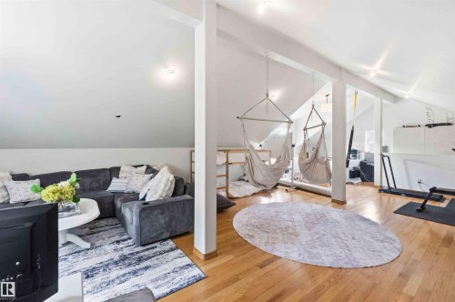 Spacious loft area featuring vaulted ceilings, exposed beams, and light wood-finish flooring - #17 A 15031 Twp Road 462, Rural Wetaskiwin County, AB - Indoor