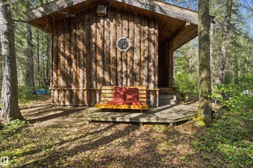Log cabin exterior with an octagonal window and covered porch - #17 A 15031 Twp Road 462, Rural Wetaskiwin County, AB - Outdoor