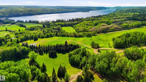 Expansive acreage featuring abundant mature trees, open grassy areas, and a visible body of water - #17 A 15031 Twp Road 462, Rural Wetaskiwin County, AB - Outdoor With Body Of Water With View