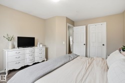 Neutral wall paint with trim, wood-finish flooring, and white interior doors - 