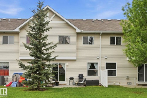 Rear exterior featuring light-toned horizontal siding and a gabled roofline - 164 150 Edwards Drive, Edmonton, AB - Outdoor With Exterior