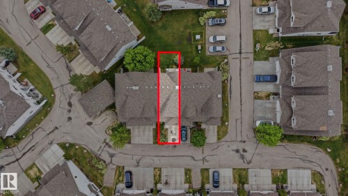 Townhome property featuring a private driveway, attached garage, and a manicured rear lawn - 164 150 Edwards Drive, Edmonton, AB -  With View