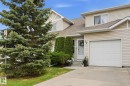 Siding exterior with a peaked roofline, attached single-car garage, concrete driveway, and front entryway - 164 150 Edwards Drive, Edmonton, AB  - Outdoor 