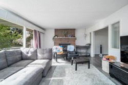 Living area featuring wood-finish flooring and a white ceiling - 