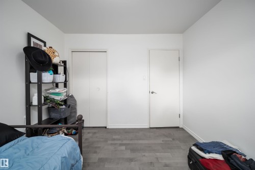 Room featuring neutral white walls and wood-finish flooring - 6403 132 Street, Edmonton, AB - Indoor