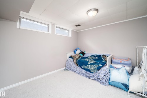 Room featuring a dropped ceiling, wall-to-wall carpeting, and light gray painted walls - 6403 132 Street, Edmonton, AB - Indoor