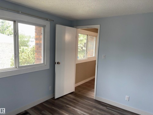 Room featuring light blue walls, white trim, and wood-finish flooring - 167 Ridgewood, St. Albert, AB - Indoor Photo Showing Other Room