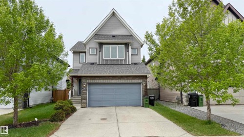 Contemporary home with a peaked roofline, gray siding, and stone accents - 3962 Claxton Loop, Edmonton, AB - Outdoor With Facade