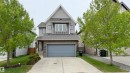 Contemporary home with a peaked roofline, gray siding, and stone accents - 3962 Claxton Loop, Edmonton, AB  - Outdoor With Facade 