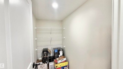 Recessed lighting illuminates an interior closet space featuring multiple wire shelving units - 3962 Claxton Loop, Edmonton, AB - Indoor
