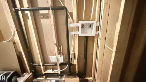 Framed interior wall featuring visible plumbing and electrical rough-ins - 3962 Claxton Loop, Edmonton, AB - Indoor Photo Showing Other Room