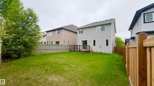 Expansive backyard featuring a wood-finish privacy fence and a composite deck with railings - 3962 Claxton Loop, Edmonton, AB - Outdoor With Exterior