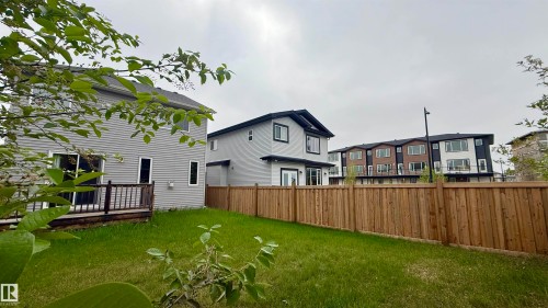 Expansive backyard with wood fencing and a wooden deck - 3962 Claxton Loop, Edmonton, AB - Outdoor With Deck Patio Veranda