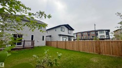 Expansive backyard with wood fencing and a wooden deck - 