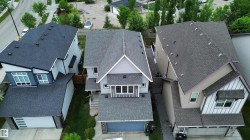Modern residential architecture featuring a light grey exterior with dark grey trim - 