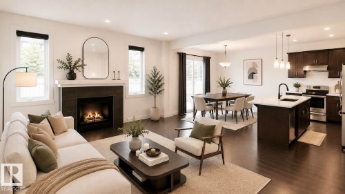 Open-concept living space featuring wood-finish flooring, a contemporary fireplace with dark tile surround and white mantel, a dining area with pendant lighting, a kitchen island with seating, and stainless steel appliances - 3962 Claxton Loop, Edmonton, AB - Indoor Photo Showing Living Room With Fireplace