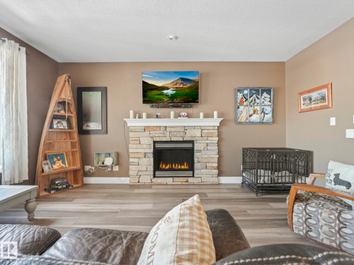 6210 53 Avenue, Beaumont, AB - Indoor Photo Showing Living Room With Fireplace