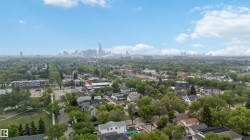 Expansive aerial perspective showcasing a mature residential neighborhood with abundant tree cover - 