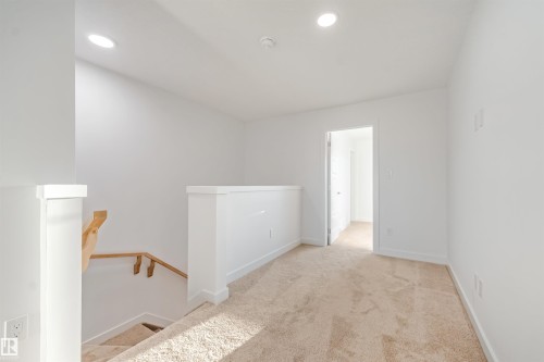 Loft area featuring recessed lighting, plush carpet, and a white painted railing - 1511 211 Street Nw, Edmonton, AB 