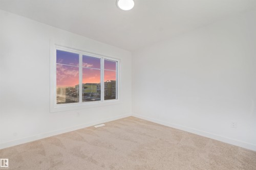 White walls with a single window featuring a three-pane design - 1511 211 Street Nw, Edmonton, AB 