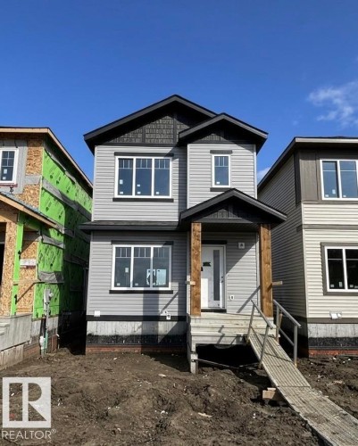 Two-story residence featuring gray horizontal siding and dark shingle accents - 1503 211 Street, Edmonton, AB 