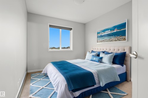 Bedroom featuring light gray walls, a window with a roller shade, and a flush mount ceiling light - 17844 61 Street, Edmonton, AB 