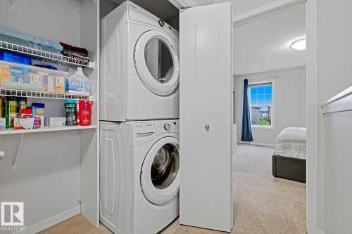 Stackable washer and dryer unit with adjacent wire shelving for storage - 17844 61 Street, Edmonton, AB 