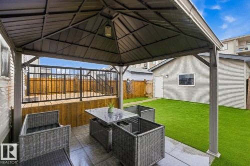 Covered patio area featuring a metal gazebo, paver stone flooring, and a ceiling-mounted light fixture - 17844 61 Street, Edmonton, AB 