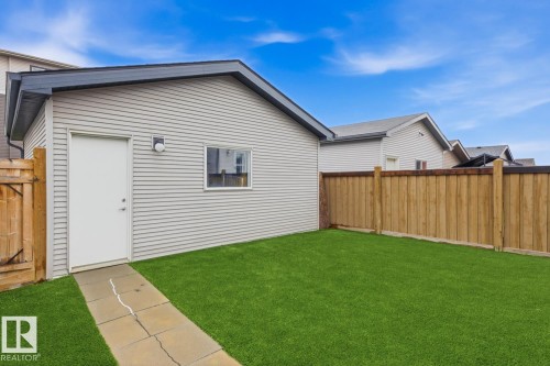 Detached garage with horizontal siding, a side entry door, and a single window - 17844 61 Street, Edmonton, AB 