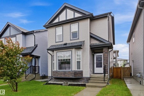 Modern residential exterior featuring light-colored horizontal siding and dark trim accents - 17844 61 Street, Edmonton, AB 
