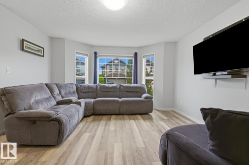 Spacious living area featuring light wood-finish flooring and light-toned walls - 17844 61 Street, Edmonton, AB 