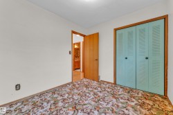 Interior room featuring light-colored walls and patterned carpet flooring - 