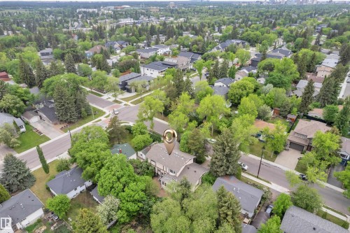 Aerial perspective showcasing a residential area with extensive tree canopy - 10819 54 Avenue, Edmonton, AB 