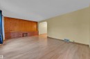 Living area featuring light wood-finish flooring and light yellow walls - 10819 54 Avenue, Edmonton, AB 