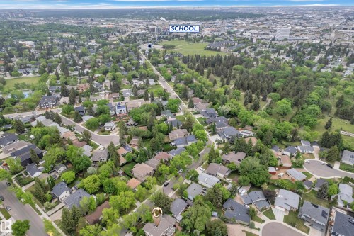 Aerial perspective showcasing a residential neighborhood with abundant mature trees and proximity to extensive green spaces - 10819 54 Avenue, Edmonton, AB 